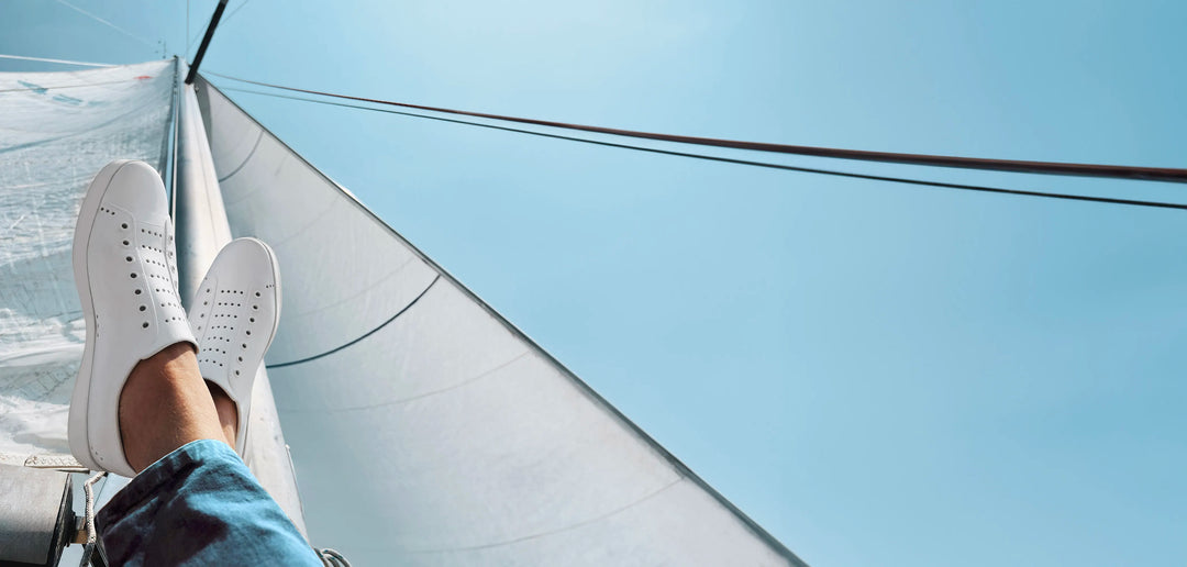 Feet up, sailing in white Monacos